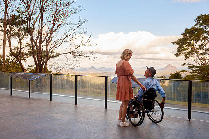 Couple a the scenic viewpoint looking out to the Glass House Mountains at Mary Cairncross Park 
