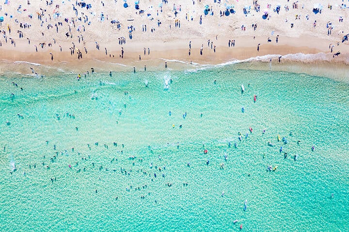 Bondi Beach aerial view on a perfect summer day with people swimming and sunbathing. Bondi is one of Sydney’s busiest beaches and is located on the East Coast of Australia 