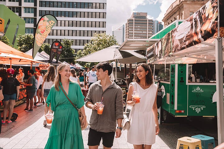 Group of friends walking through the Brisbane City Markets