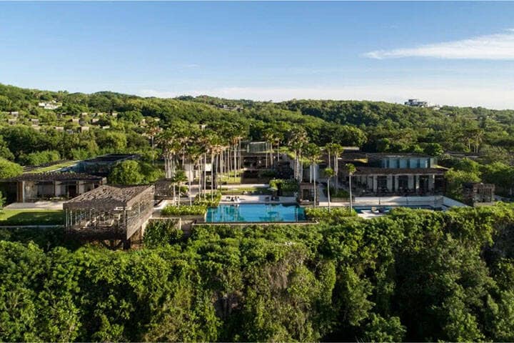 Lush greenery surrounding pool area of Alila Resort Uluwatu, Bali